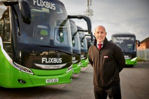 Phil-Hitchen-pictured-with-some-of-Belle-Vue-Manchesters-new-Yutong-coaches-which-operate-on-FlixBus-routes